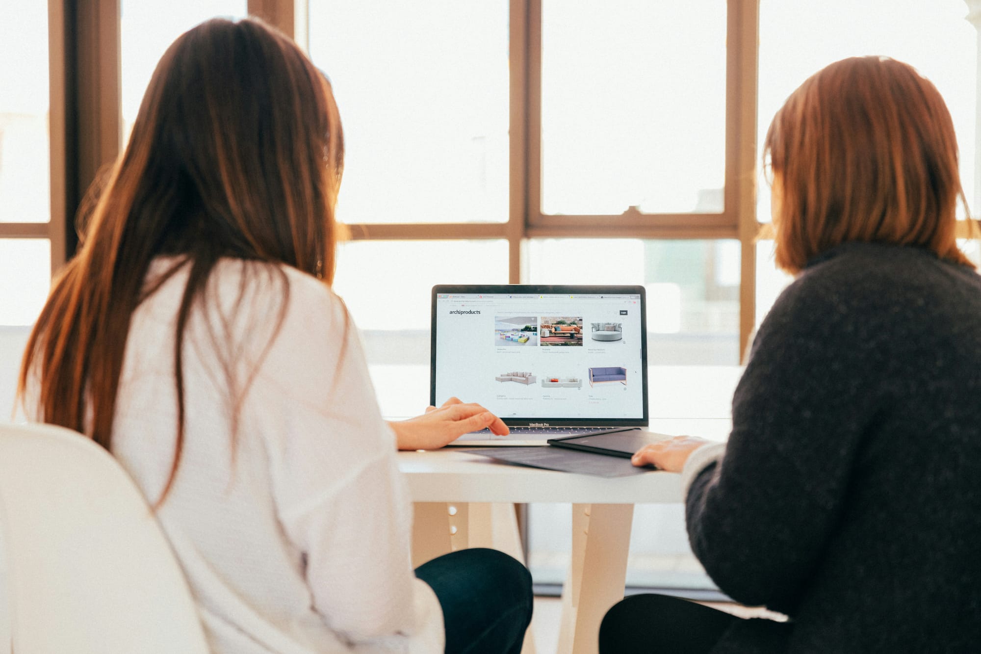 women looking at laptop - How Many Cold Emails To Send Per Day