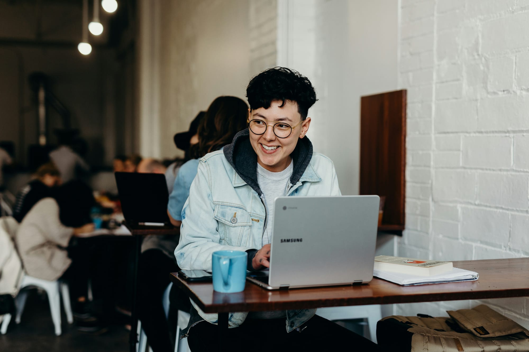 woman in coffee shop using No Code Workflow Automation Platform