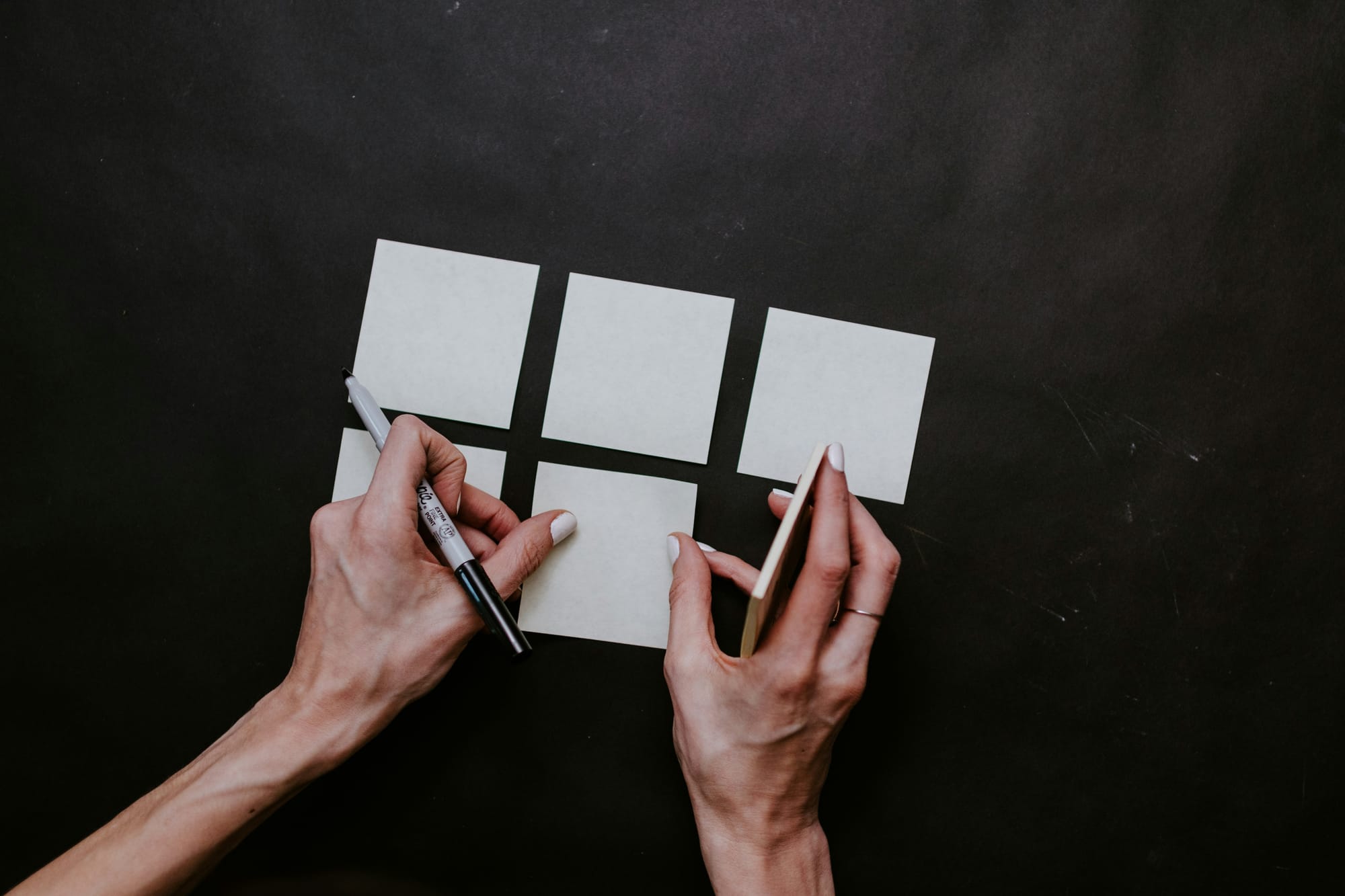 woman adding sticky notes for reminders while using Content Creation Tools