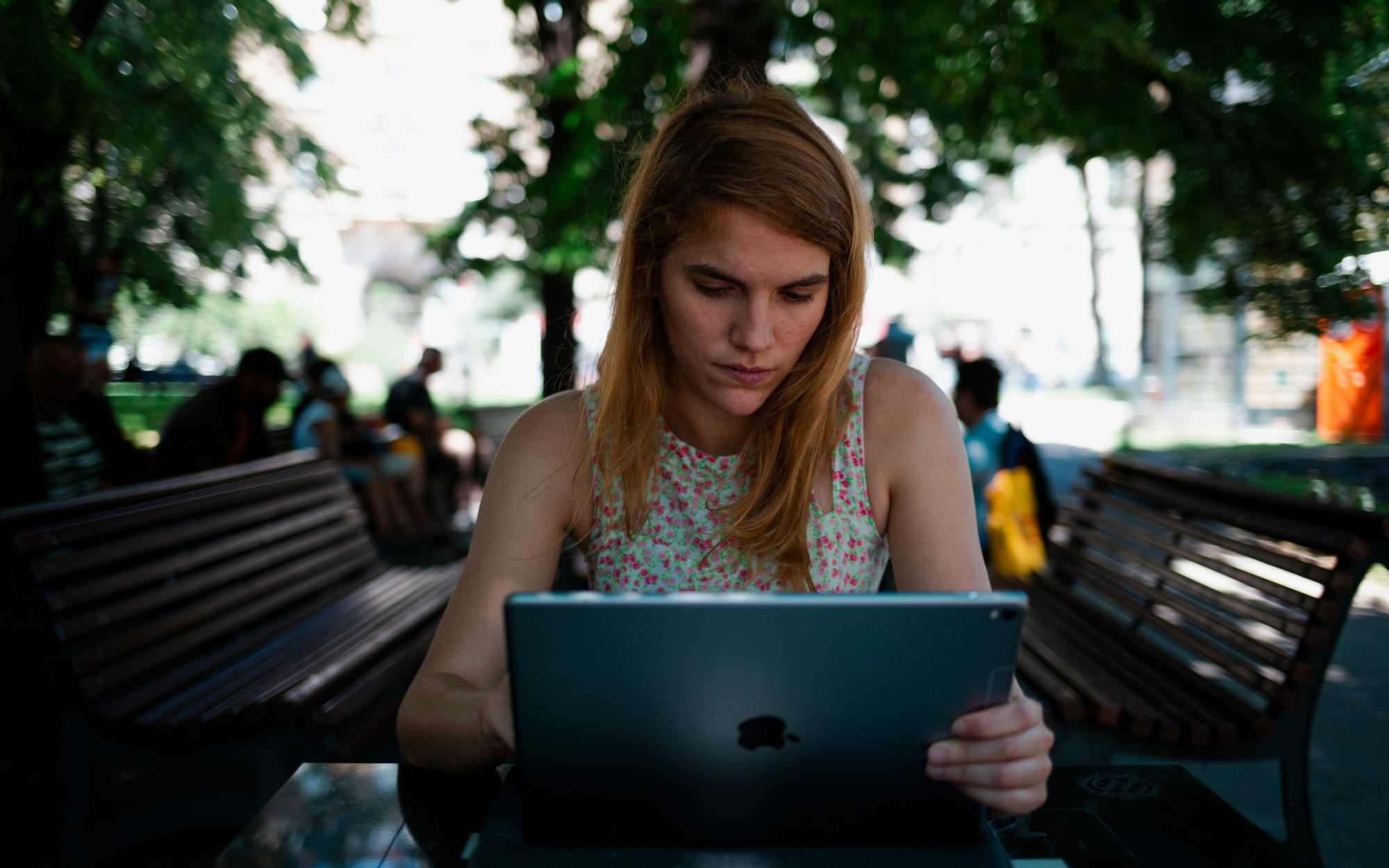 woman sitting outdoor and working on Social Media Content Creation Tools