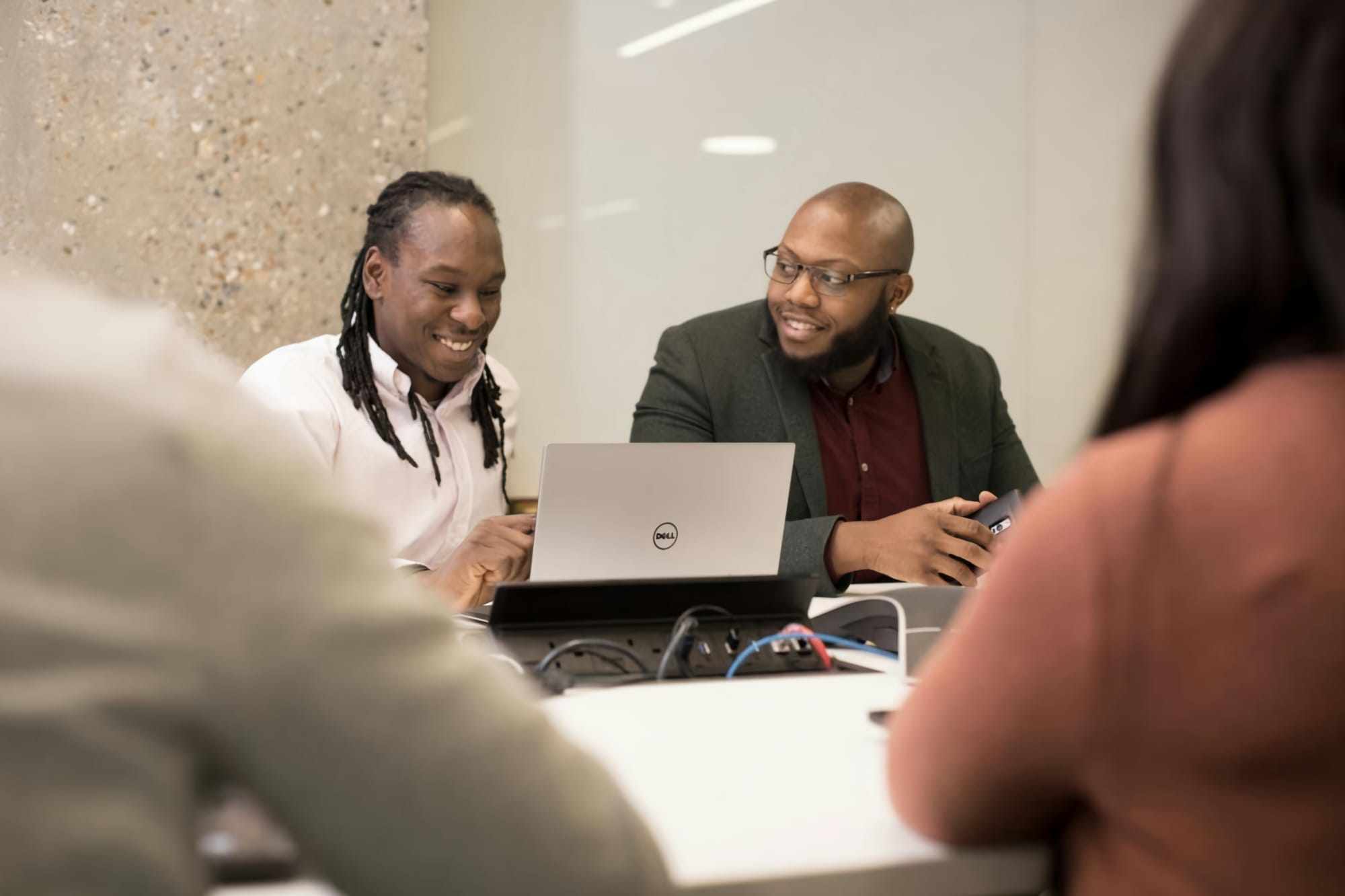 people in a meeting discussing Marketing Automation Workflow Examples