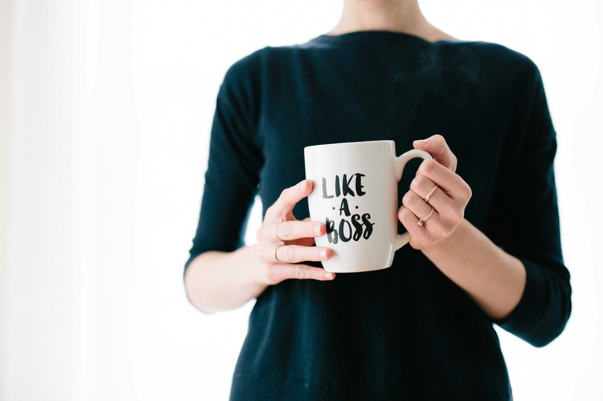 Women Holding the Like a Boss Cup - Content Automation Services
