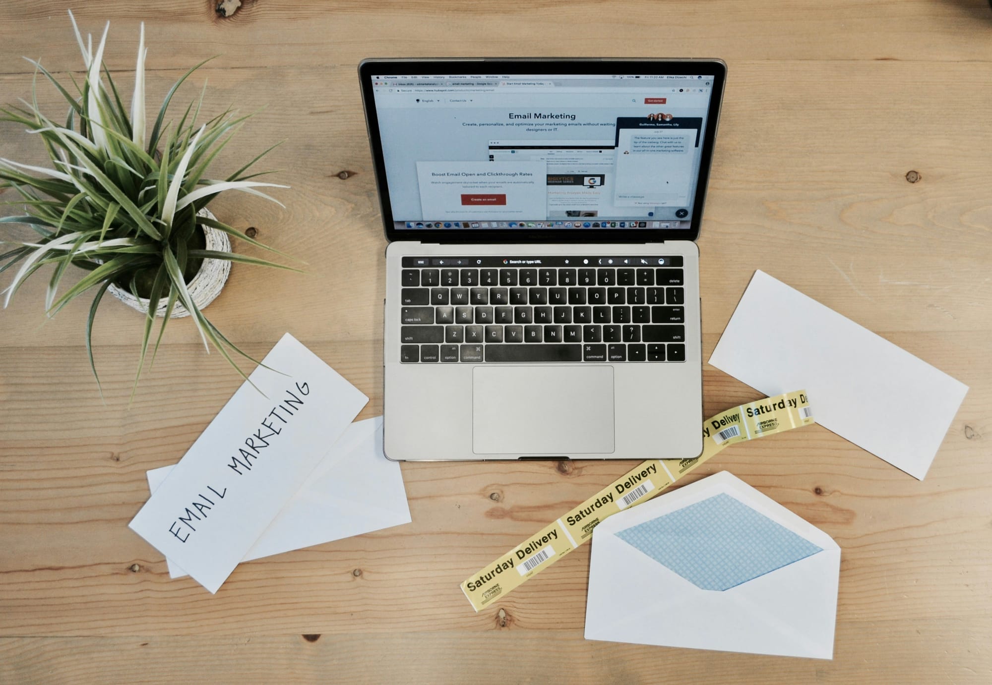 laptop on a table with envelops - Instantly Cold Email