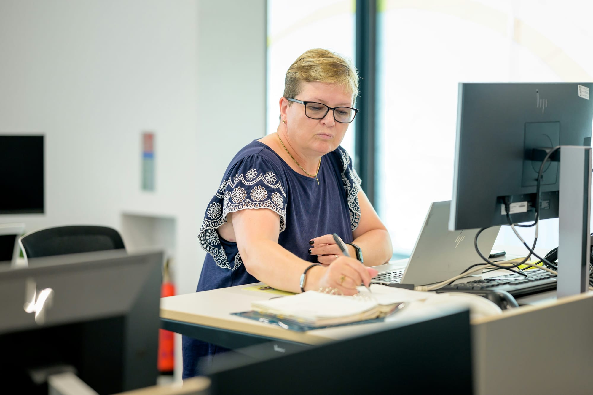 woman making notes while working - Cold Outreach Strategy