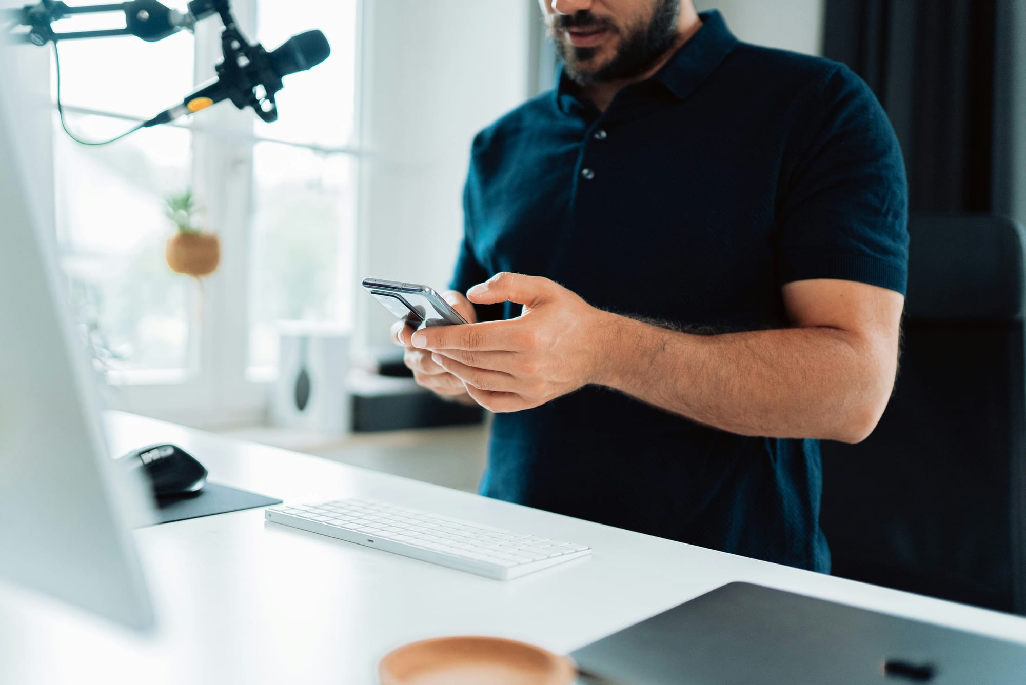 Man Holding the Phone infront of the Mic - Content Automation Services