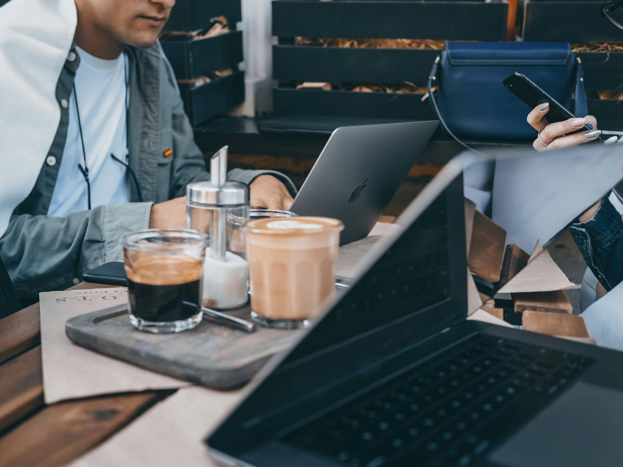 person in coffee shop working on content repurposing workflow