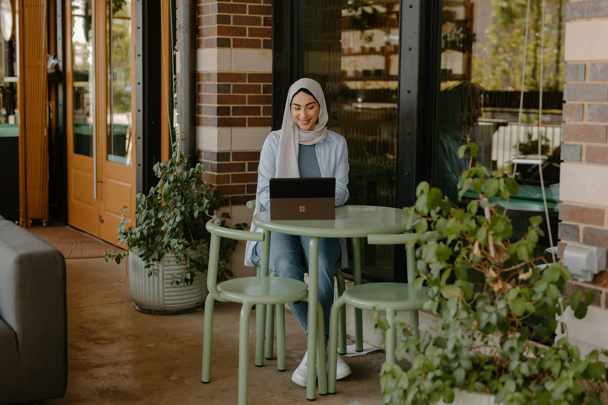 person working from coffee shop - Rytr Alternatives